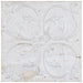 Decorative white tile with intricate patterns on a light background